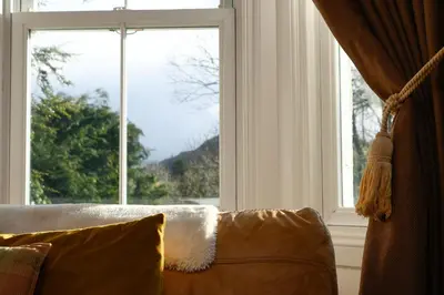 a couch sitting in front of a large window at Cologin in Oban