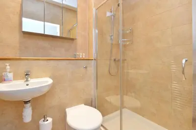 a bathroom with a shower and a toilet and a sink at Home by The Meadows, close to City Centre in Edinburgh