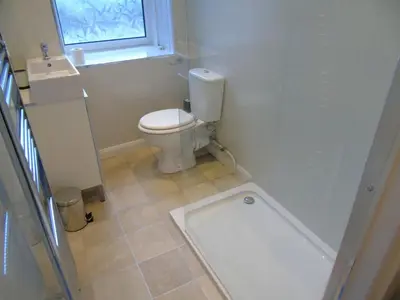 a bathroom with a toilet and a window at Snug - Tearlag Apartment in Helensburgh