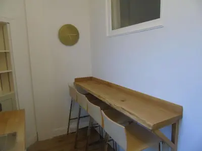 a table in a room with a row of chairs at Snug - Tearlag Apartment in Helensburgh