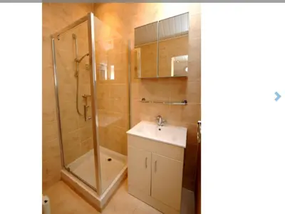 a bathroom with a shower and a sink and a toilet at Cheerful One bedroom cottage with parking space. in Glasgow