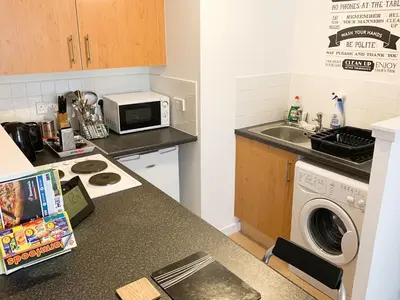 a kitchen with a sink and a microwave at Glasgow City Centre Studio Apartment in Glasgow