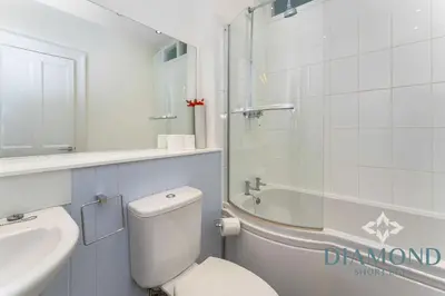 a bathroom with a toilet and a sink and a shower at Spacious 1 Bed Ground Floor Apartment with Garden in Edinburgh