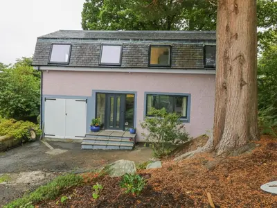 a pink house with a tree in front of it at Dunaivon Cottage in Helensburgh