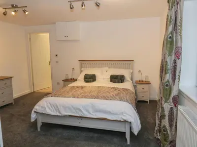 a bedroom with a bed with two pillows on it at Dunaivon Cottage in Helensburgh