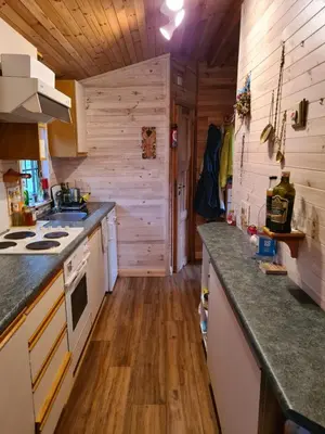 a kitchen with wooden floors and a counter top at Unique Caravan with Outdoor Space Lodge in Ballantrae
