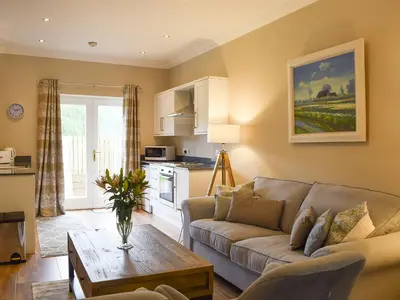 a living room with a couch and a table at Craigmore View-Uk34220 in Aberfoyle