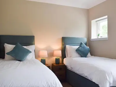 two beds sitting next to each other in a bedroom at Craigmore View-Uk34220 in Aberfoyle