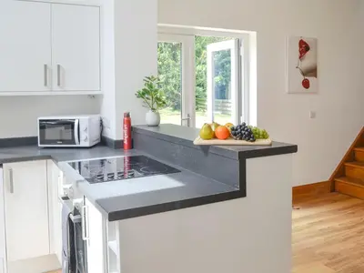 a kitchen with a counter top with fruits on a cutting board at Stronvaar in Stranraer