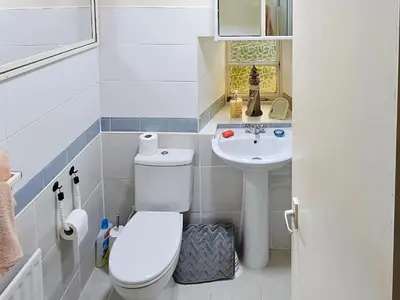 a small bathroom with a toilet and a sink at Tigh Na Maraiche in Isle of Jura