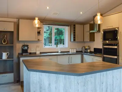 a kitchen with a large island in the middle at Riverside Lodge in Auchterarder