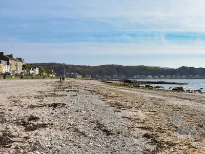 a beach with a rocky shoreline and the water at Osocozee in Millport