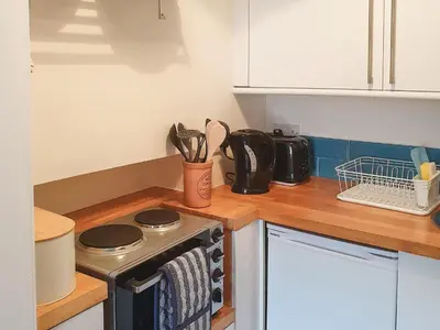 a kitchen with a stove top oven in a kitchen at Osocozee in Millport