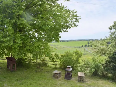 a group of picnic tables under a tree in a field at Uk7385 - Chaff House in Newmilns