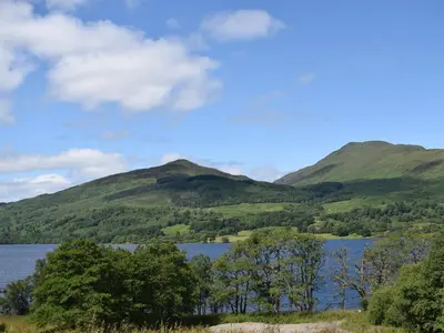 a view of a lake with mountains in the background at The Barn in Fintry