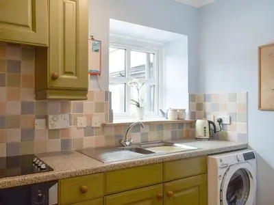 a kitchen with a sink and a washing machine at The Barn in Fintry