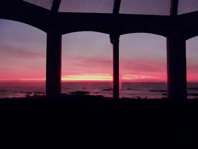 a sunset seen through the windows of a house at Shore Cottage in Bellochantuy