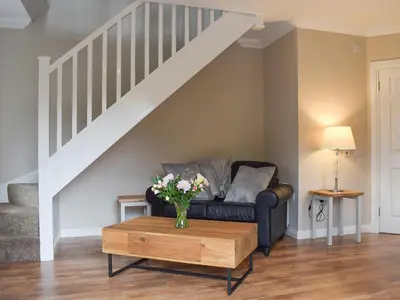 a living room with a couch and a coffee table at Faodail-Uk34218 in Aberfoyle