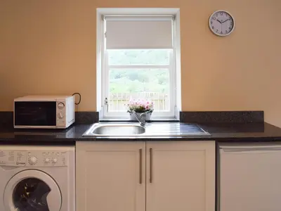 a kitchen with a sink and a microwave and a window at Faodail-Uk34218 in Aberfoyle