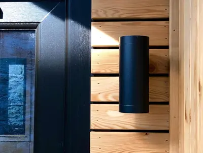 a black pole on the side of a wooden door at Trossachs Barn & Cabin - boutique B&B in Port of Menteith
