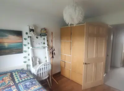 a bedroom with a bed and a cabinet at Single bedroom in quiet neighbourhood in Mount Vernon