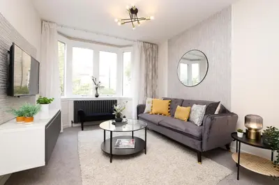 a living room with a couch and a table at JOIVY Modern 1 bed Flat in West End, close to Princes Gardens in Edinburgh