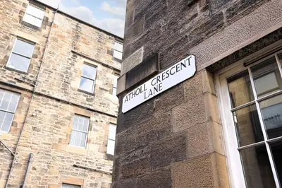 a street sign on the side of a brick building at JOIVY Modern 1 bed Flat in West End, close to Princes Gardens in Edinburgh