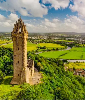 an old tower on top of a green hill at Cosy Cottage in Stirling