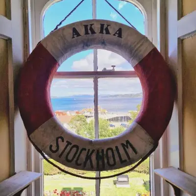a window with a sign that reads scotium at Coorie Braw Cottage in Kirn