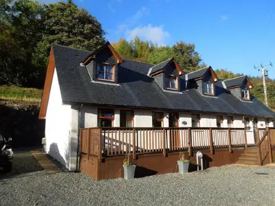 a white house with a black roof at The Cobbler Cottage - Loch Lomond and Arrochar Alps in Arrochar