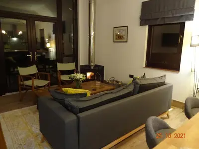 a living room with a couch and a table at The Stables near Glasgow in Balmore