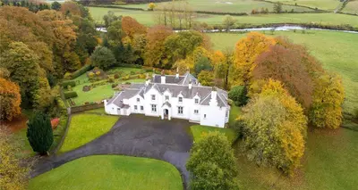 an aerial view of a large white house at Park of Drumquhassle in Glasgow
