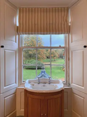 a bathroom with a sink in front of a window at Park of Drumquhassle in Glasgow