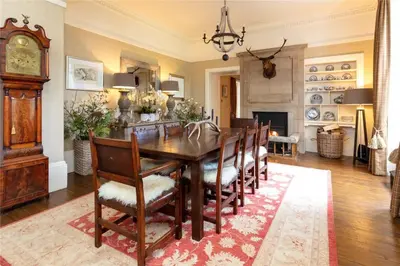 a dining room with a table and chairs at Park of Drumquhassle in Glasgow