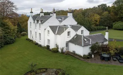 an aerial view of a large white house at Park of Drumquhassle in Glasgow
