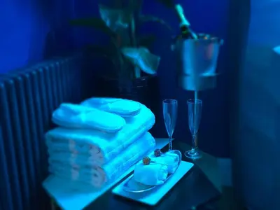 a table with a cake and two glasses on it at The NEW Blue Horse Suite at The Grumpy Schnauzer B&B Luxury Private Indoor Hot Tub Breakfast in Bed in Airdrie