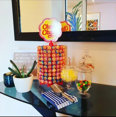a glass table with a candy bar on top of it at The NEW Blue Horse Suite at The Grumpy Schnauzer B&B Luxury Private Indoor Hot Tub Breakfast in Bed in Airdrie
