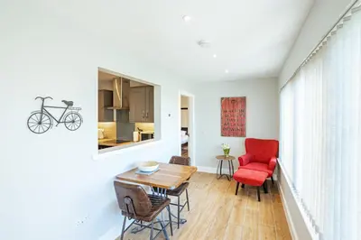 a living room with a table and a red chair at Kestrel Lodge 6 with Hot Tub in Newton Stewart