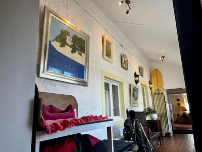 a room with a wall with a bench and a picture at Whitehouse in Uplawmoor