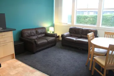 a living room with a couch and a table at The Old School in Dalavich