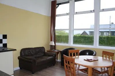 a living room with a couch and a table at The Old School in Dalavich