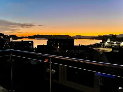 a view of a city with the sunset in the background at The Penthouse in Oban