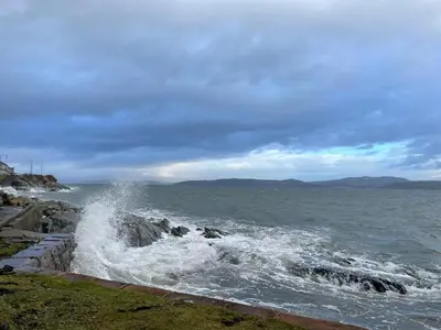 a wave crashing on the rocks in the ocean at Dunoon River Clyde Flat in Innellan