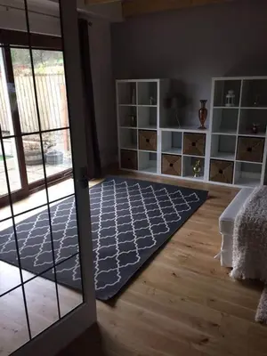 a living room with a rug on the floor at Kilburn Holiday Cottage in Largs