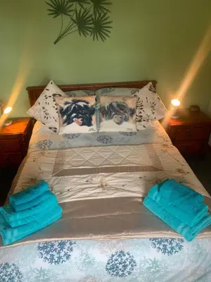 a bed with two pillows on top of it at Snowberry Cottages No1 in Onich