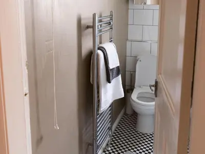 a bathroom with a toilet and a towel rack at Cozy two bed flat near Glasgow Airport & Paisley - Pass the Keys in Paisley
