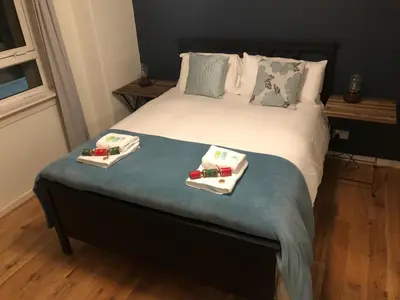 a bed with two plates of food on it at Cozy two bed flat near Glasgow Airport & Paisley - Pass the Keys in Paisley