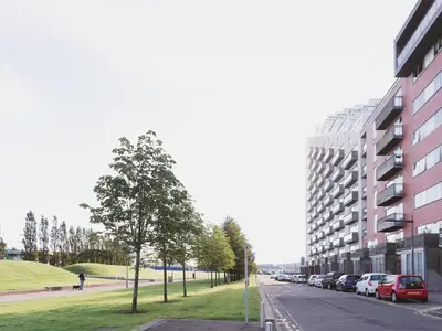 a street with cars parked on the side of a building at Lovely 2-Bed Flat Glasgow Harbour FREE parking - Pass the Keys in Glasgow