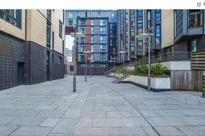 an empty street in a city with tall buildings at Oswald Apartment - Glasgow City Centre in Glasgow