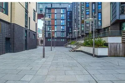 a city street with tall buildings and street lights at Oswald Apartment - Glasgow City Centre in Glasgow